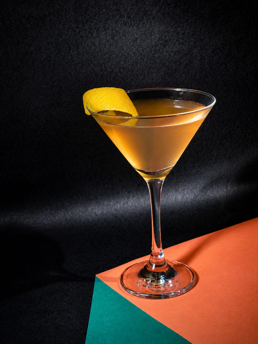 Coquetel autoral em taça martini com twist de limão